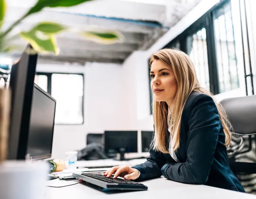 Health Information Technician Smiling at Desk